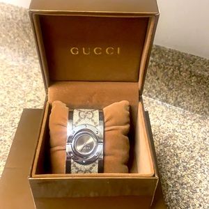 Gucci cuff watch with monogram band.